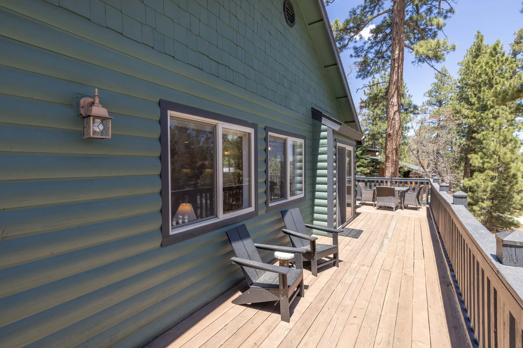 Daytime view of the private hot tub on the deck at Pine Grove Cabin, surrounded by pine trees